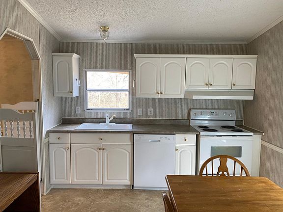 Kitchen with view of sink, dishwasher and stove. Lots of cabinet space!