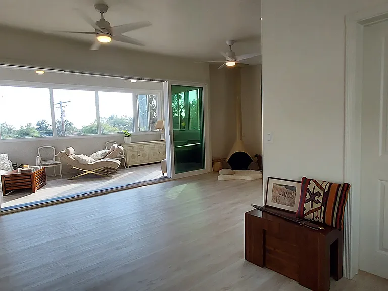 This photo shows the space with tri-slider and curtains fully open, creating the Great Room