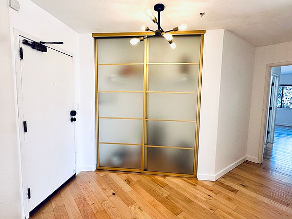 Entry door, lobby, and coat/storage closet. Looking into Bedroom #2
