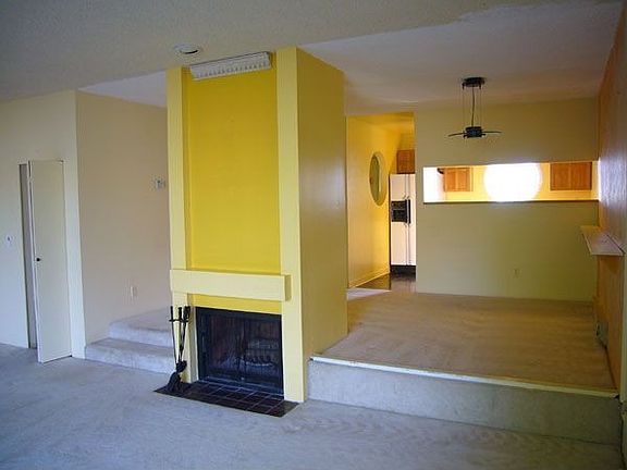 Large, sunken living room opens to dining room and kitchen.