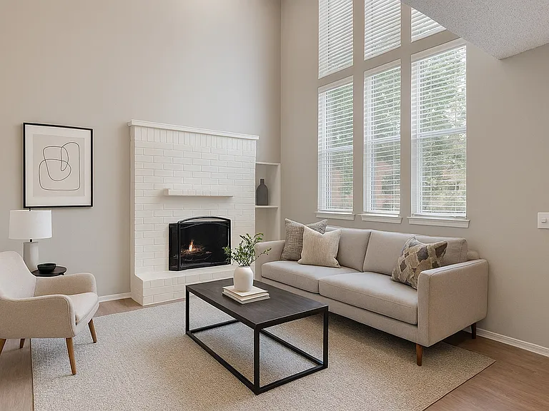 Cozy living room featuring a fireplace and 12 ft ceilings. Cozy living room featuring a fireplace and 12 ft ceilings.