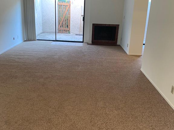 Livingroom with Fireplace and entry to Private Patio