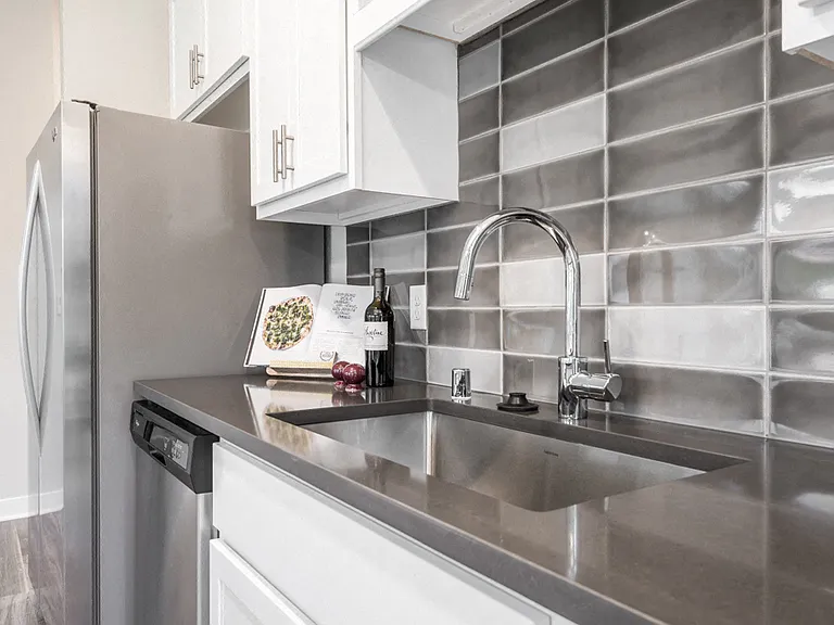 Kitchens feature beautiful tile backsplashes and quartz countertops.