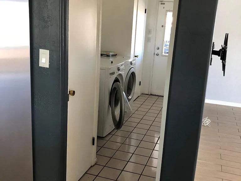 Laundry area with extra storage and door to the carport.