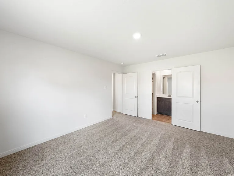 The master suite has a spacious bedroom, en-suite bathroom and walk-in closet.
