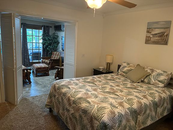 Large bedroom with queen size bed and dresser.