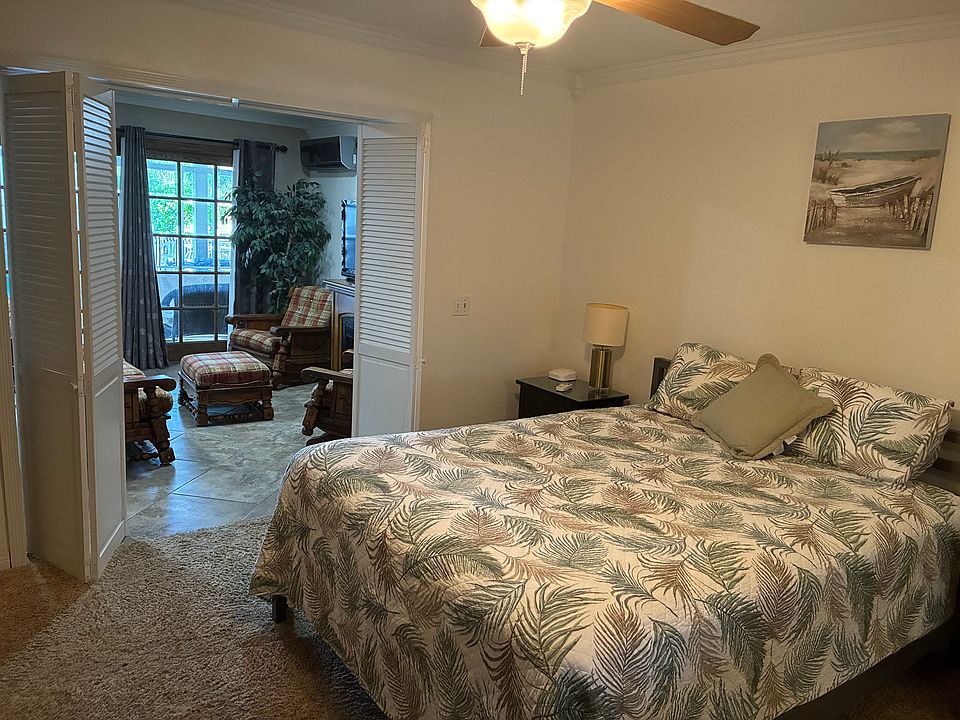 Large bedroom with queen size bed and dresser.