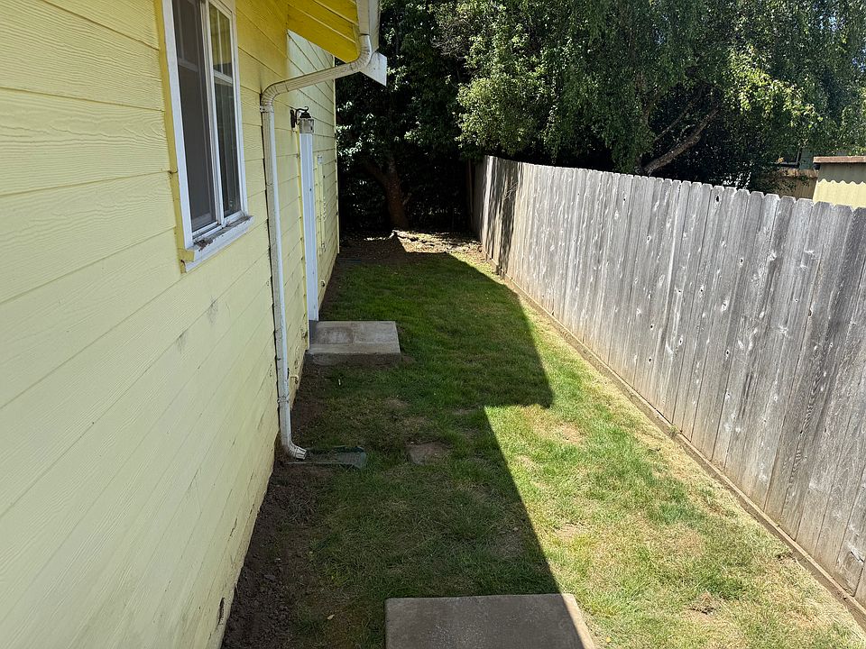 The west side of the backyard showing the garage entrance