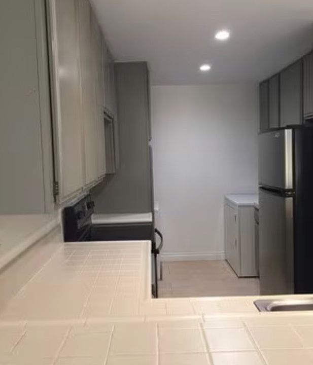 kitchen with washer and fryer, fridge, stove, microwave and dishwasher + plenty of storage and pantry