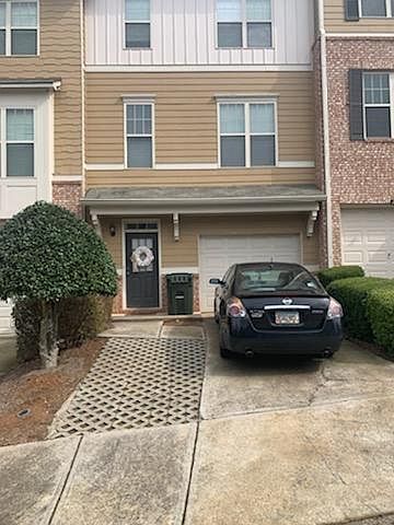 Front door and garage entrance. Additional parking space.
