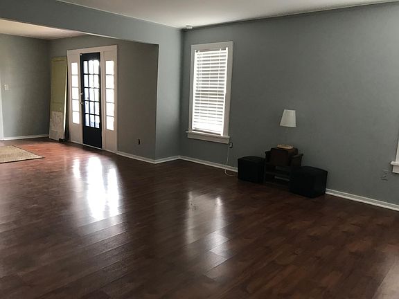 Large living & dining rooms with side access French door on