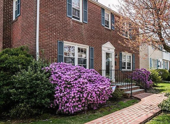 Blooming azaleas & brick walk lend to curb appeal