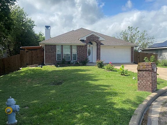 Single story home with a front lawn and a garage