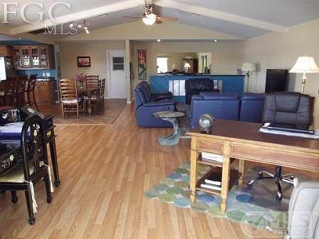 Massive family room with ample space for the 2 river-view desks, breakfast area and wet bar,  33' x 23'! Opens onto large cathedral ceiling lanai.