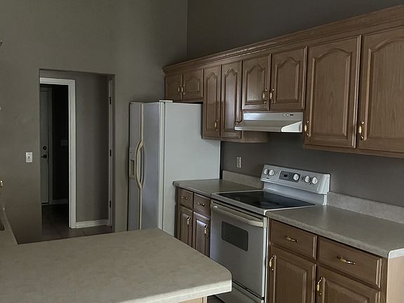 Kitchen with dishwasher, microwave, stove and fridge