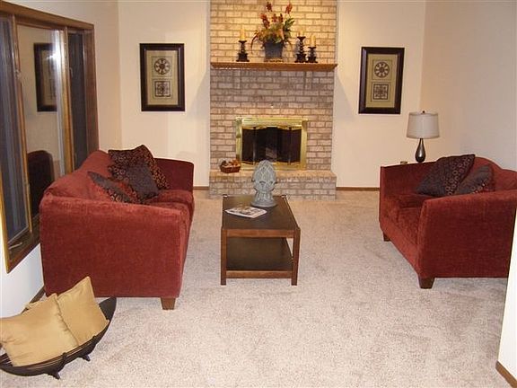Cozy upper level family room with wood burning fireplace