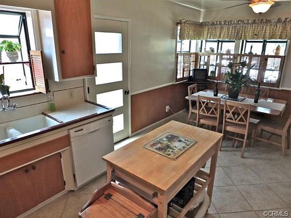 Kitchen looking into dining area with driveway door to the left.
