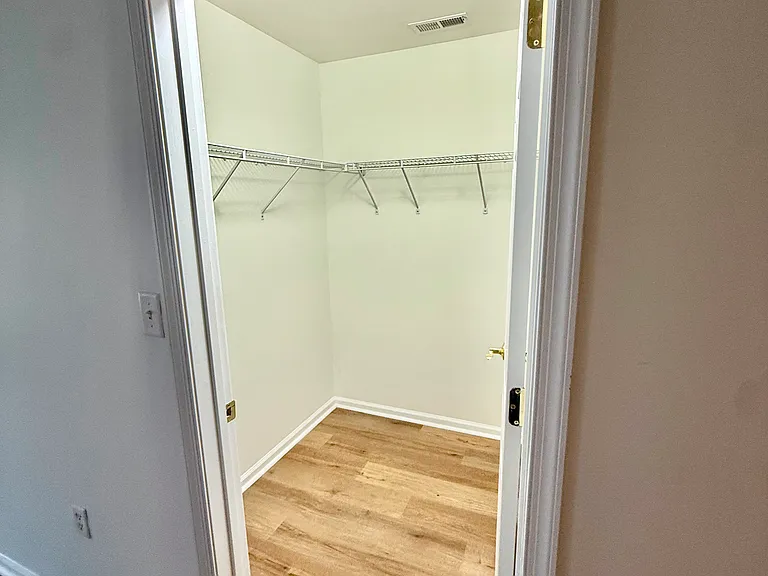 One of two large walk in closets in primary room.
