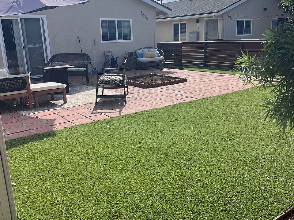 Front yard featuring artificial turf and hard scape.