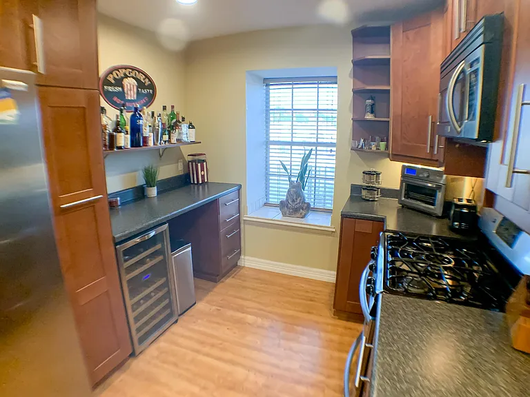 Kitchen includes bar nook, window alcove, and plenty of cabinet storage.