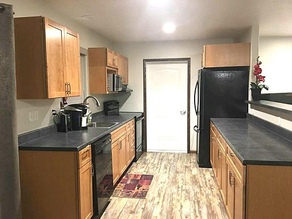 Modern kitchen with newer appliances, open to living area