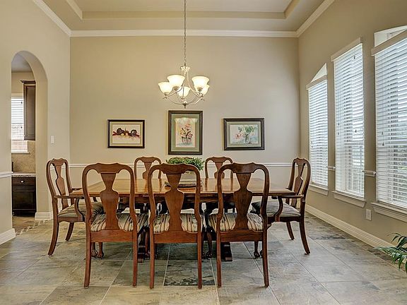 The tray ceiling with crown molding add to the elegance of this room
