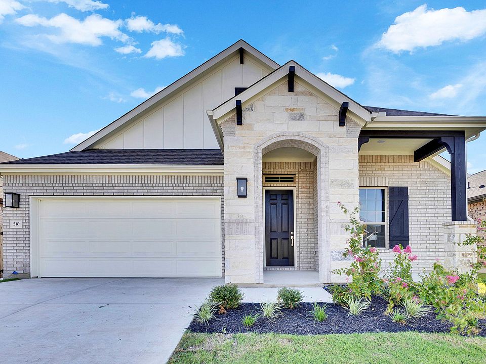 Luxurious stone and brick facade with sleek black accents exudes sophistication in Sunfield s serene