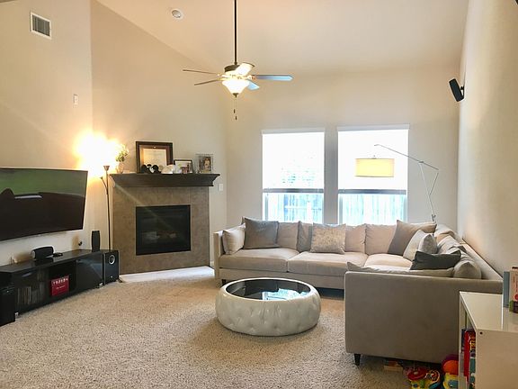 Living room with vaulted ceiling.