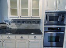 Beautiful SS appliances, granite countertop and modern backsplash.