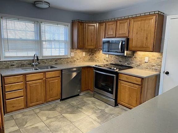 Kitchen with quartz countertops, smoothtop range with convection oven and OTR microwave