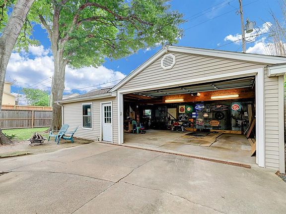 Spacious 2-car garage with two additional spaces for storage, workshop, or home gym!