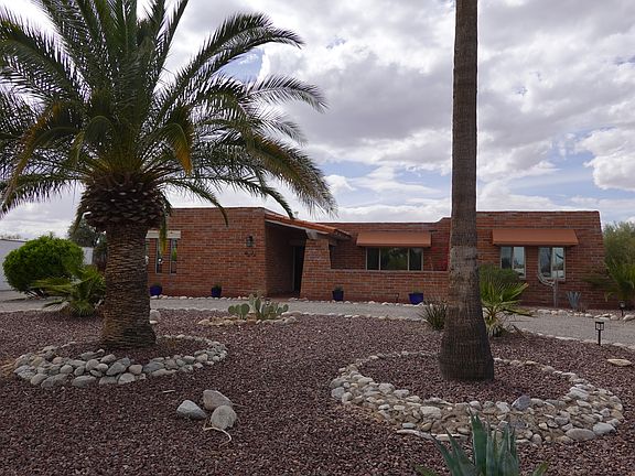 Territorial burnt adobe home with modern updates. Circular drive provides ample parking for guests. The house is set back from the street allowing for quiet privacy. New solar lighting accents the space.