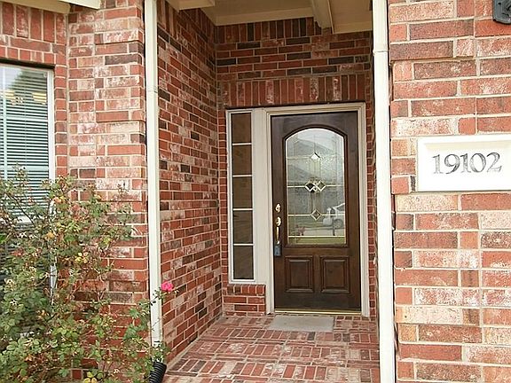 Front View Of Home With Lead Glass Front Door.