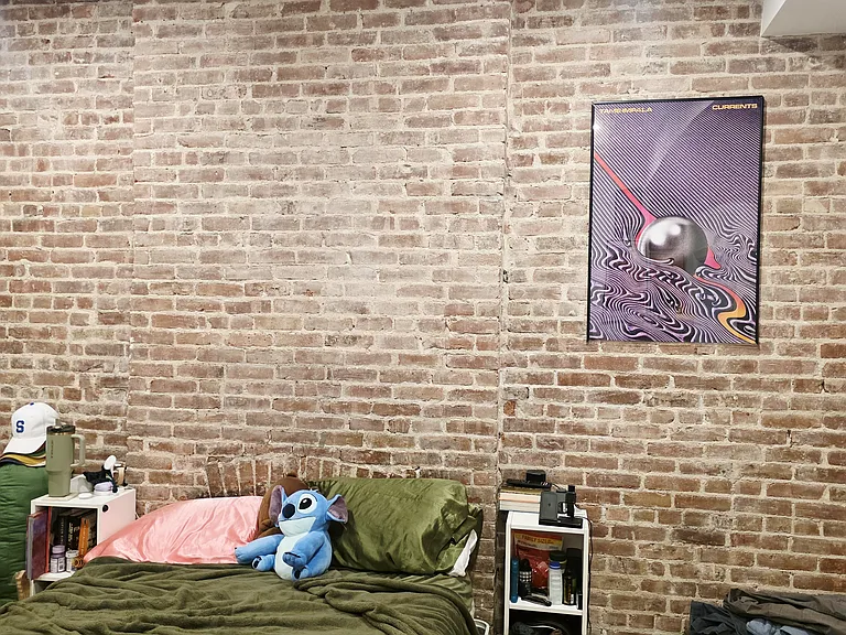 Master bedroom with exposed brick