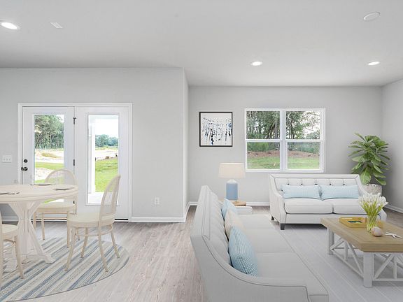 Spacious gathering room with elegant engineered wood flooring and large white-trimmed windows. - Mod