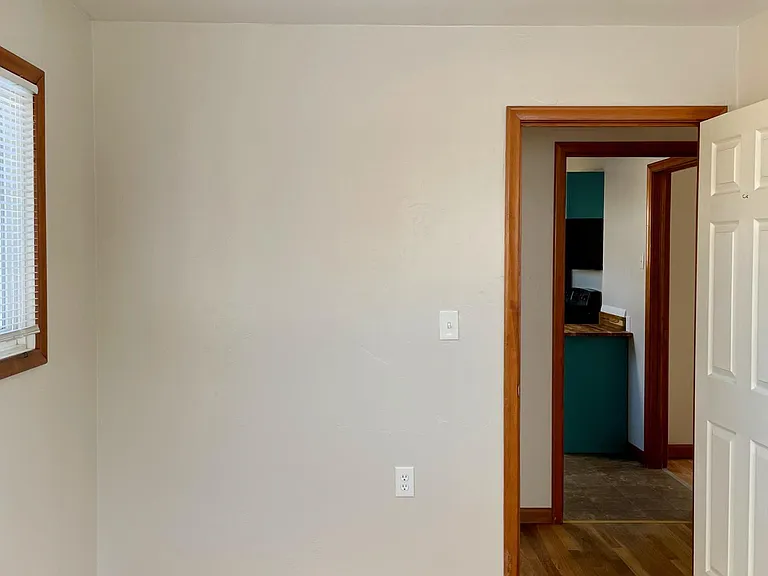 First bedroom towards hallway and kitchen