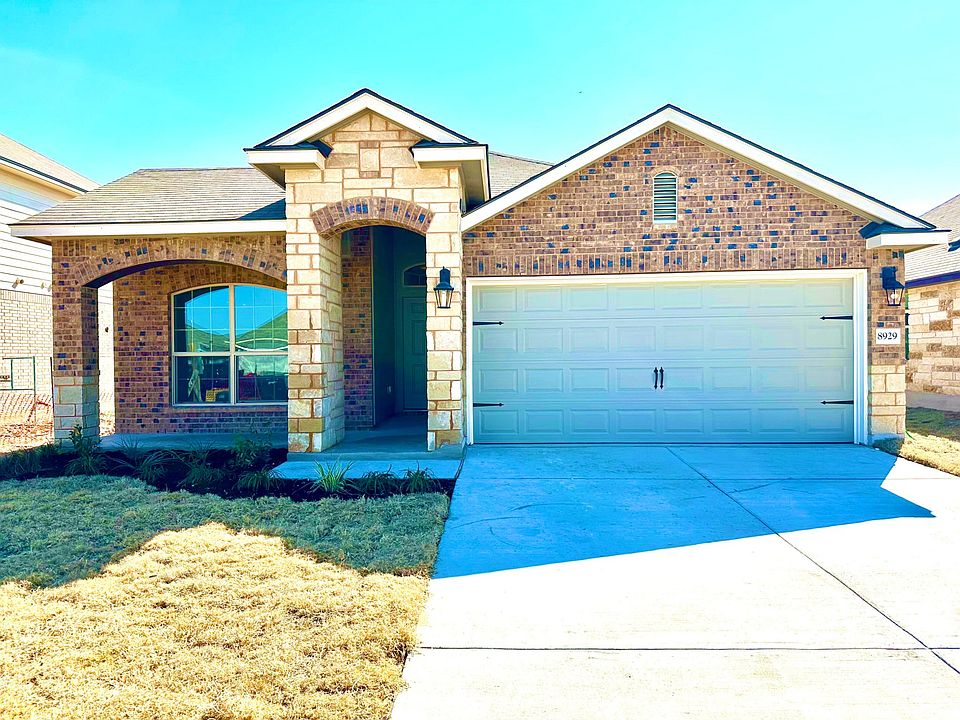 Front with limestone border and 2 car garage