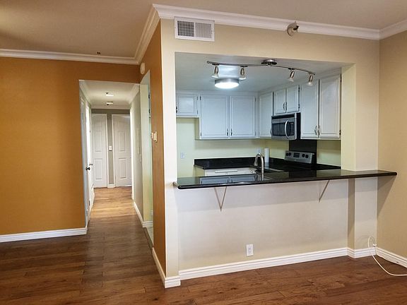 Living room, kitchen, & part of dining area