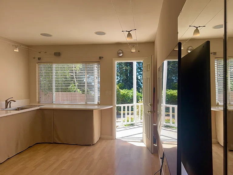 The garage has been converted into a 200 sq. ft. bonus room. It features stunning garden views, DC spotlighting, hot and cold running water, full length ballet mirror and a 50" wall mounted television.