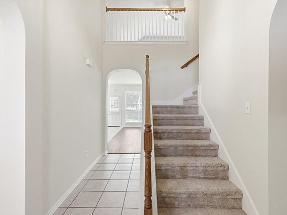And from the entryway, you see a view right through to the kitchen and back as well as the stairway up