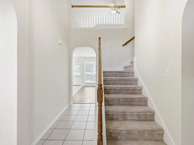 And from the entryway, you see a view right through to the kitchen and back as well as the stairway up