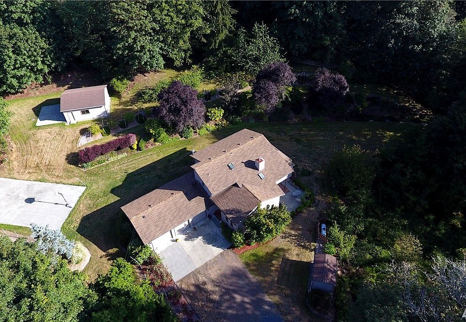 Large property that includes a sports court, detached 2 car garage/ shop and many fruit trees and plants.