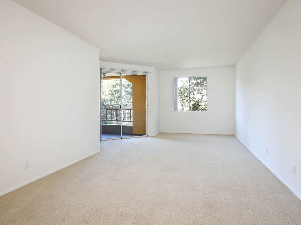 Carpeted Living Room with Balcony