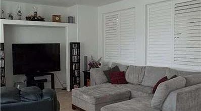Family room view with louvered shutters between family room and formal living room.