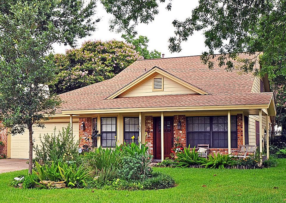 Rare 1.5 story house, roof 2009, auto garage door, and mature landscaping is warm and inviting.