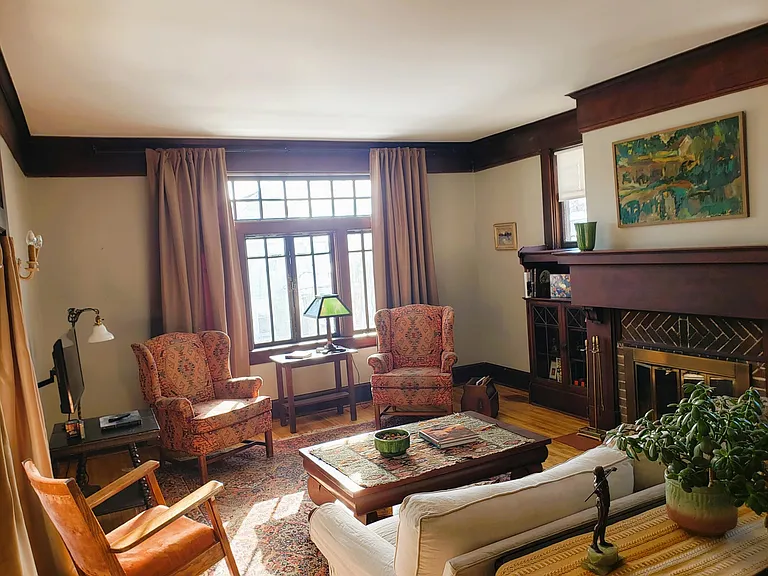 Spacious Living Room, which flows into elegant Dining Room. Staircase leads to 3 bedrooms, 1 full bath (tub and shower) upstairs, and seating area.