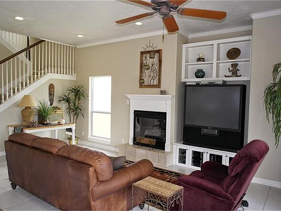 AS YOU ENTER THIS BAY HOME YOU ARE GREETED BY AN OPEN FLOOR PLAN AND THE INVITING LIVING ROOM ON THE RIGHT. THIS ROOM FEATURES  CUSTOM BUILT INS, RECESSED LIGHTING AND CROWN MOULDING PLUS A GAS LOG FIREPLACE