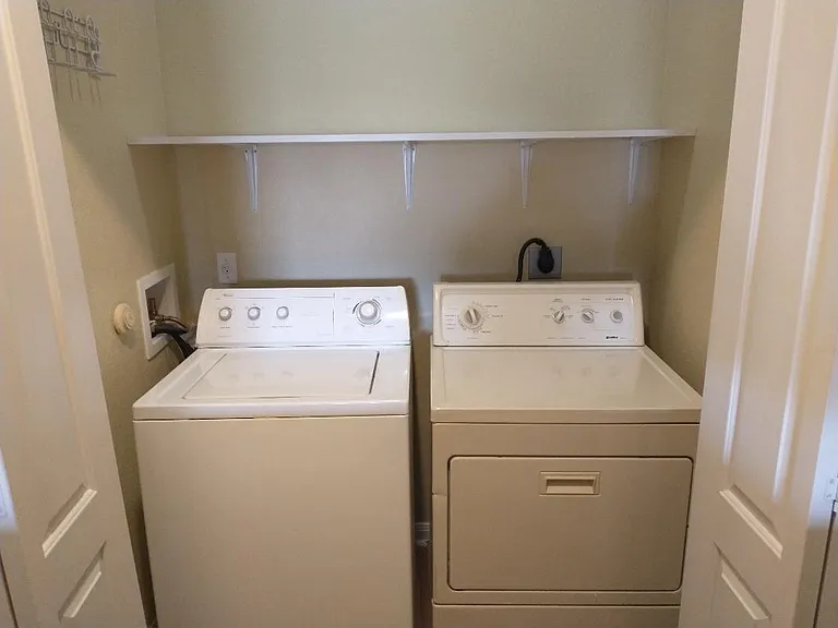 Laundry room inside apartment.