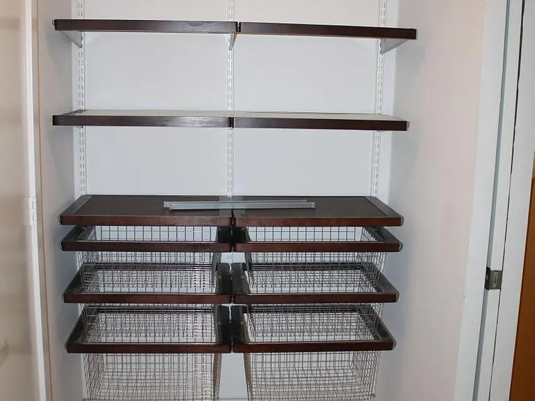 another view of walk in closet shelving and drawers in master bedroom