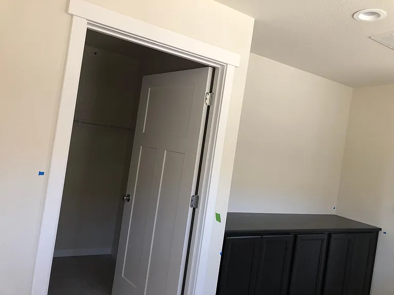 Upstairs view to laundry room and storage